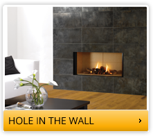 hole in the wall fireplace with outer black tiling 